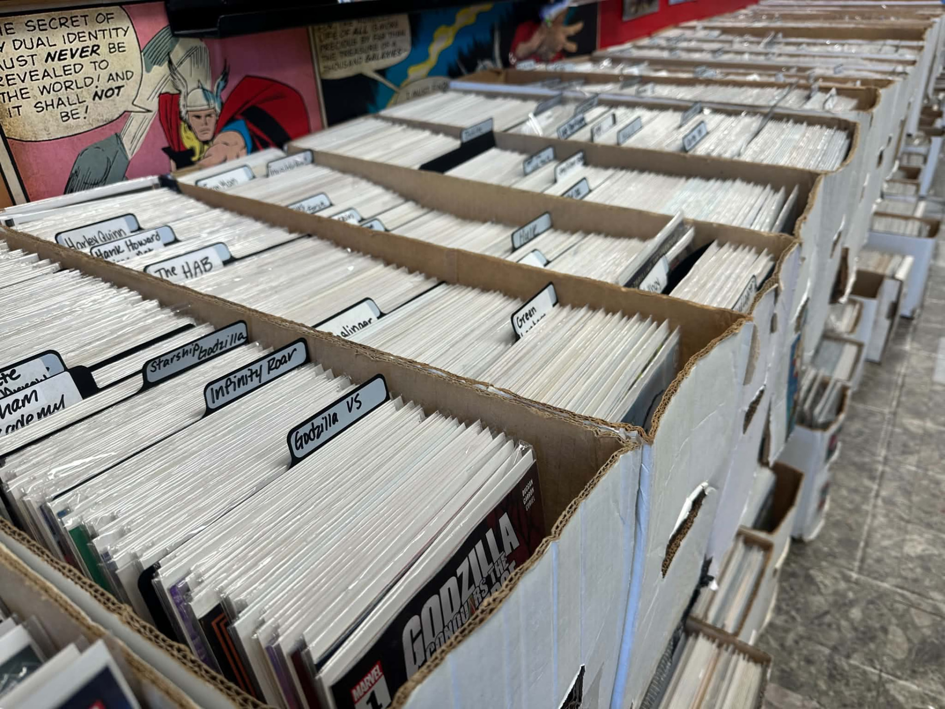 Labeled boxes of bagged-and-boarded comics ready for pull lists at the shop